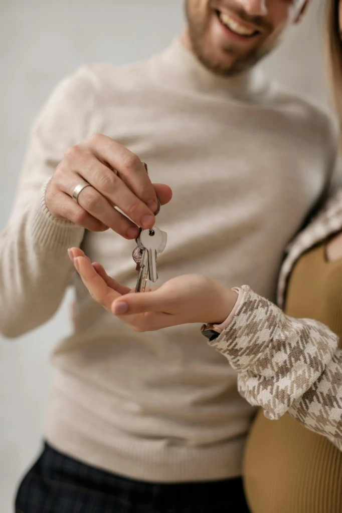 Couple exchanging the keys to their new home